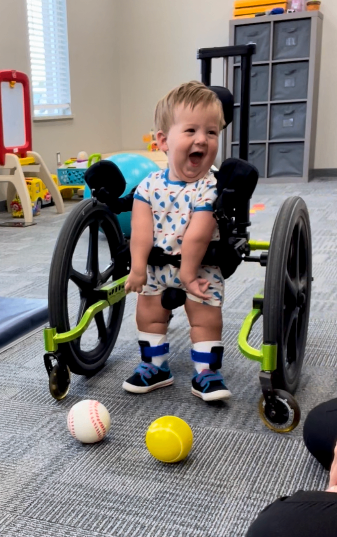 Luke practicing standing during therapy.