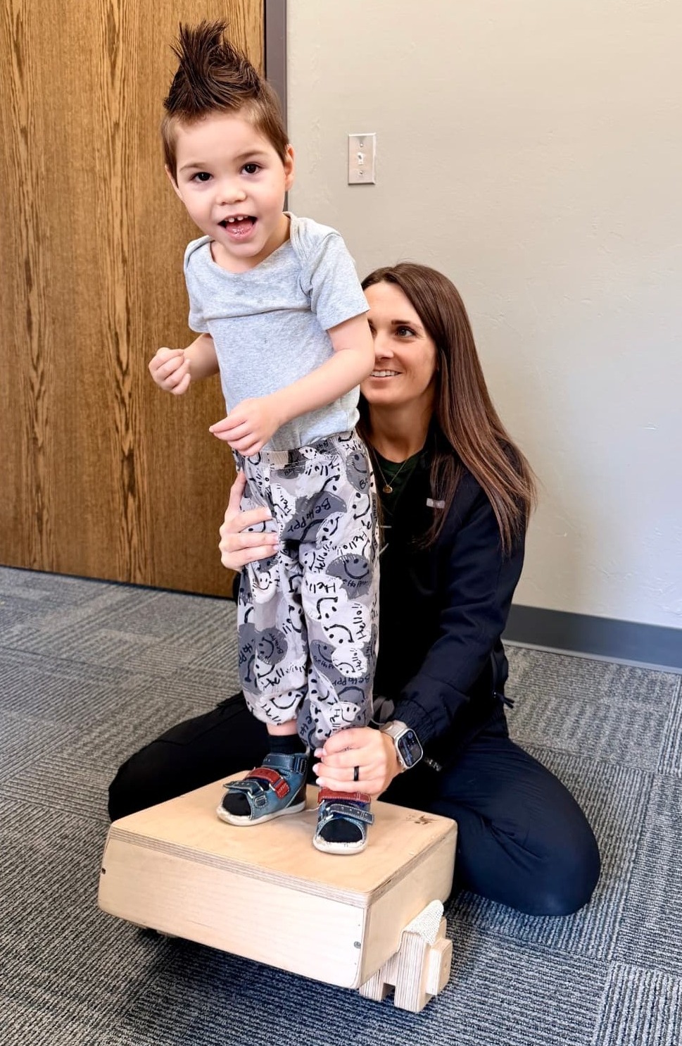 A therapist working closely with a child during a focused intensive therapy session.