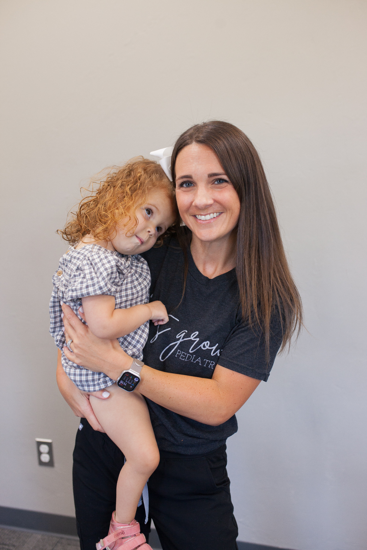 Abby with a child at Let's Grow Pediatrics