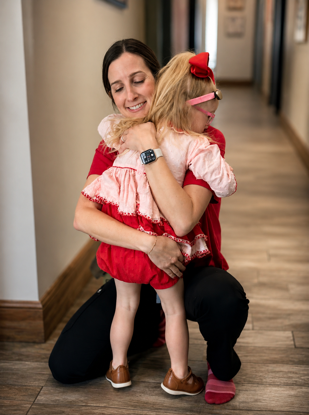 Abby hugging a child at Let's Grow Pediatrics