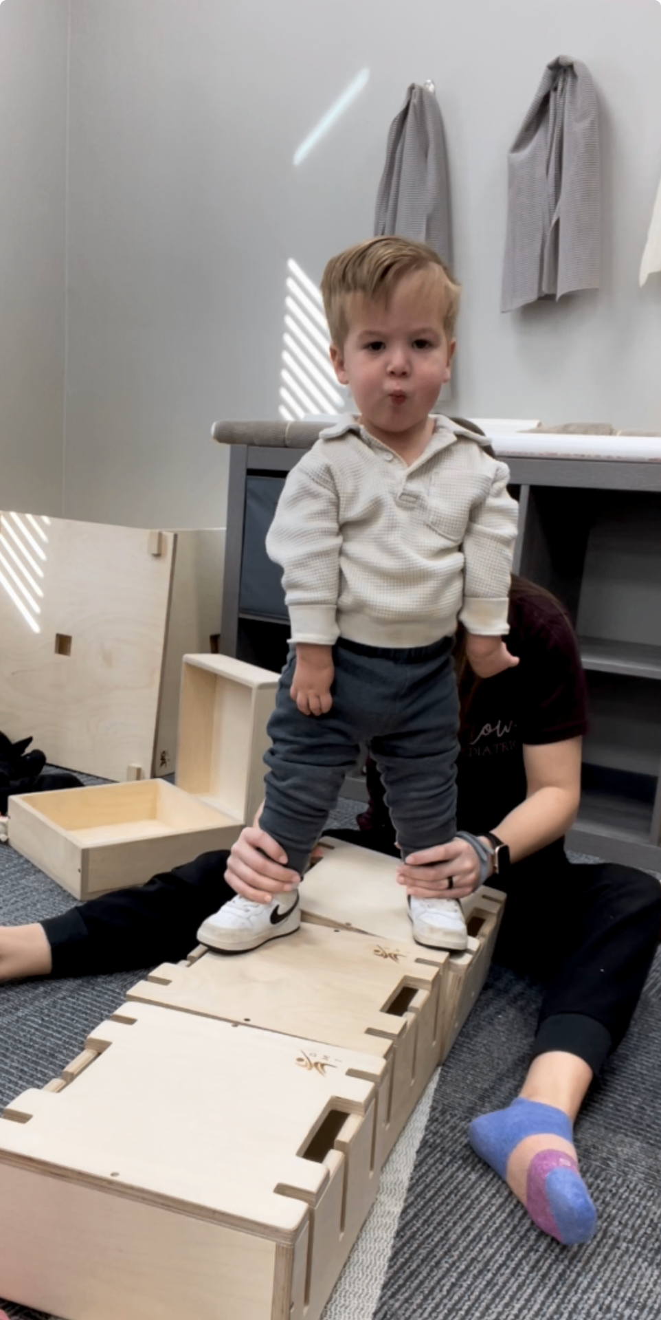 Luke standing on a therapy step.