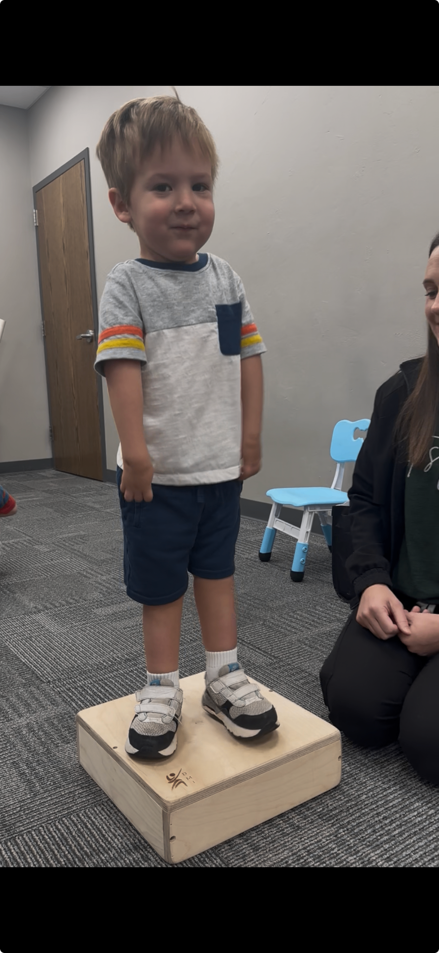 Luke standing tall on a therapy platform.