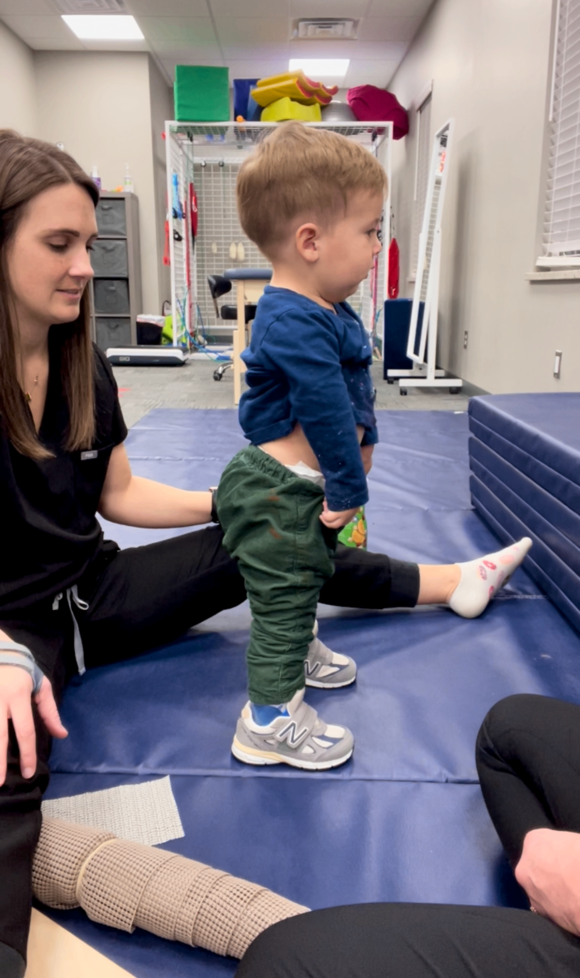 Luke using a mobility device in the clinic.